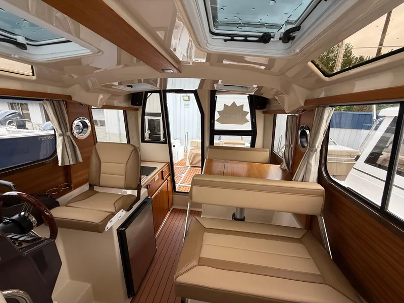 Slide: The Image of Interior of 2025 Ranger Tugs R-25 boat, featuring luxurious seating and modern design elements. - 22