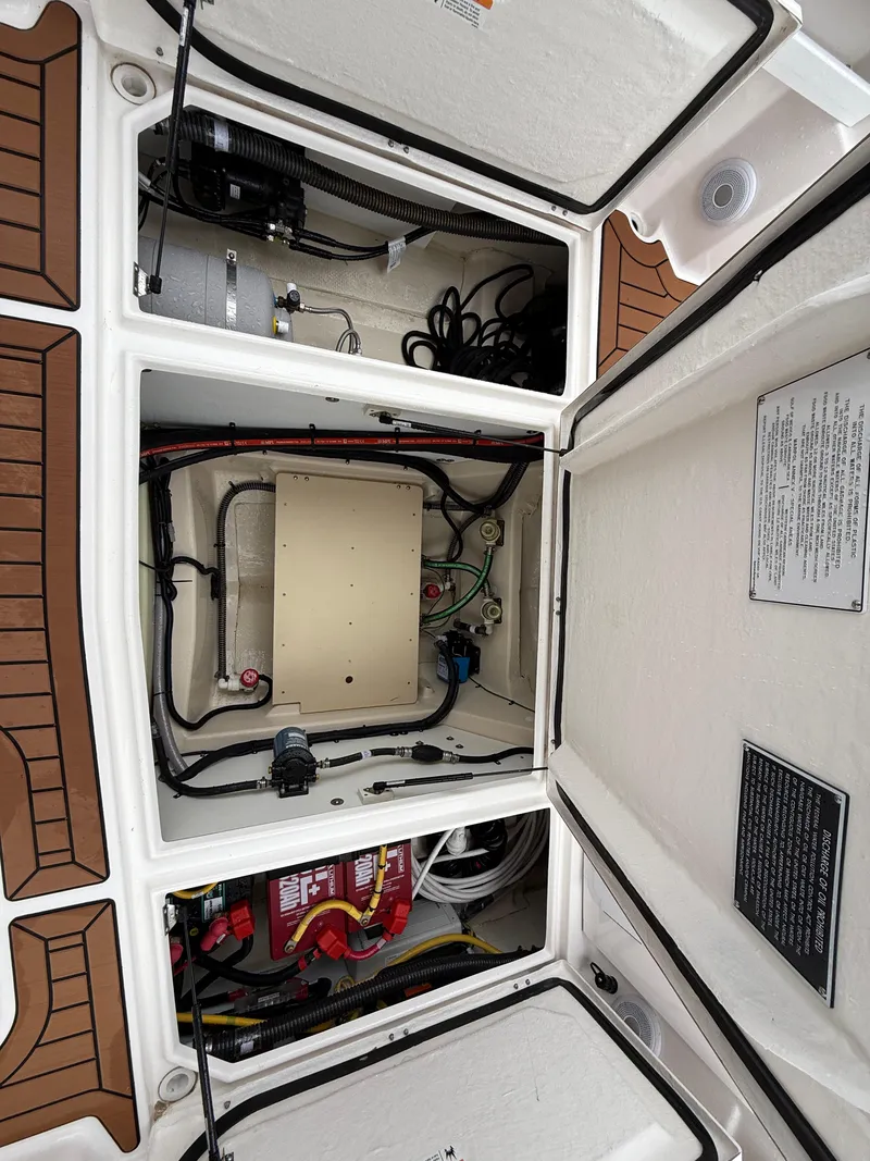 Slide: The Image of Engine compartment of 2025 Ranger Tugs R-25, showcasing wiring and components. - 25