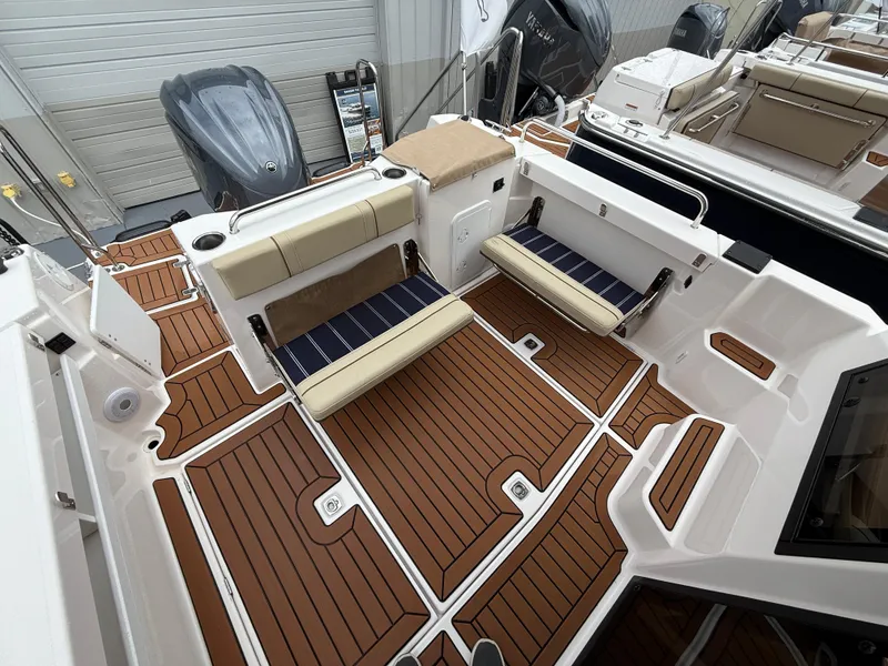 Slide: The Image of 2025 Ranger Tugs R-25 boat deck with seating and wood finish. - 8
