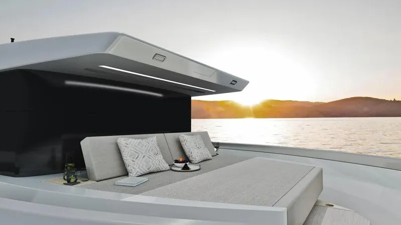 Slide: The Image of Luxurious 2026 Ladenstein L48 MIAMI yacht at sunset, featuring elegant outdoor seating. - 19