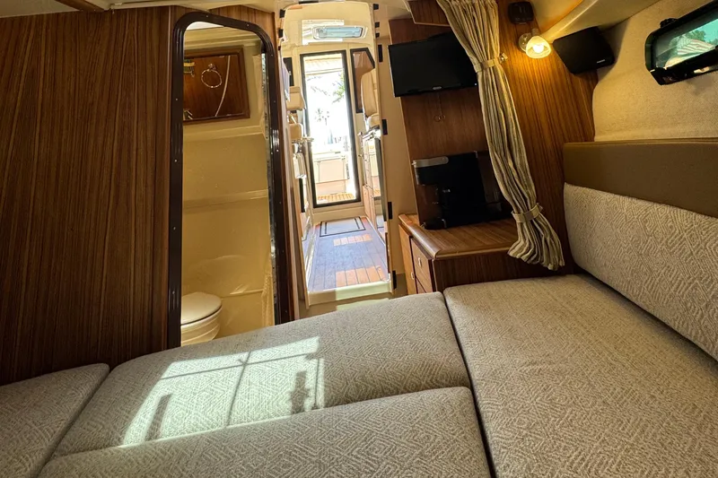 Slide: The Image of Interior of 2025 Ranger Tugs R-27 boat, featuring cozy cabin and modern amenities. - 11