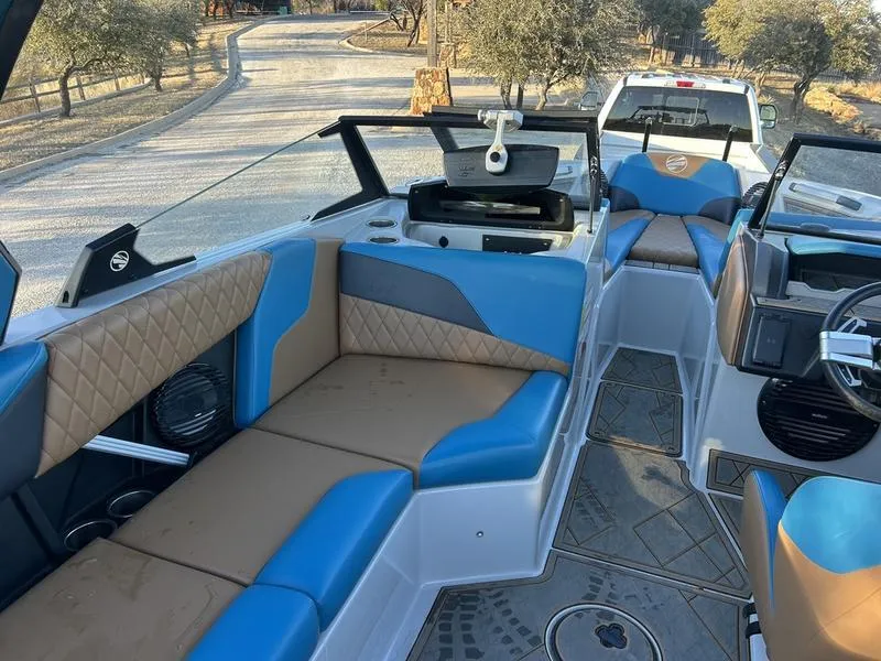 Slide: The Image of 2023 Tigé Z5 boat interior with blue and tan seating, parked on a trailer. - 4