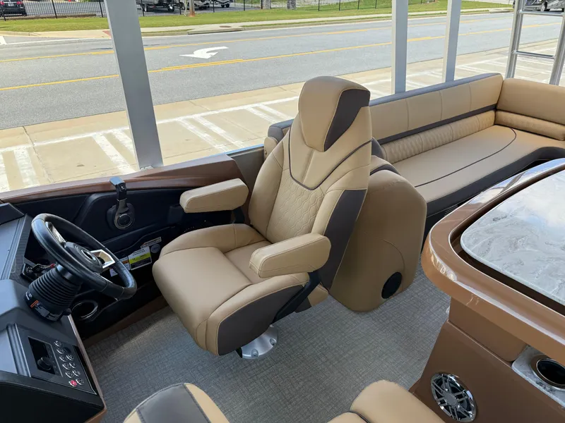 Slide: The Image of 2025 Avalon Catalina Entertainer Funship interior with plush seating and modern steering console. - 15