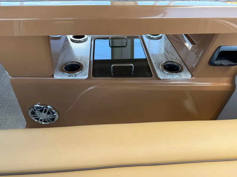 Slide: The Image of 2025 Avalon Catalina Entertainer Funship interior with cup holders and speaker. - 20