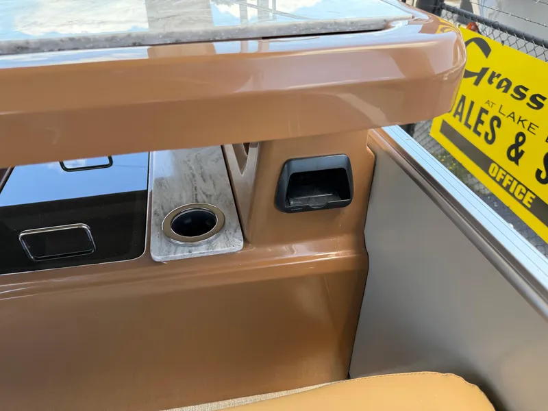 Slide: The Image of Interior detail of 2025 Avalon Catalina Entertainer Funship with cup holder and control panel. - 21