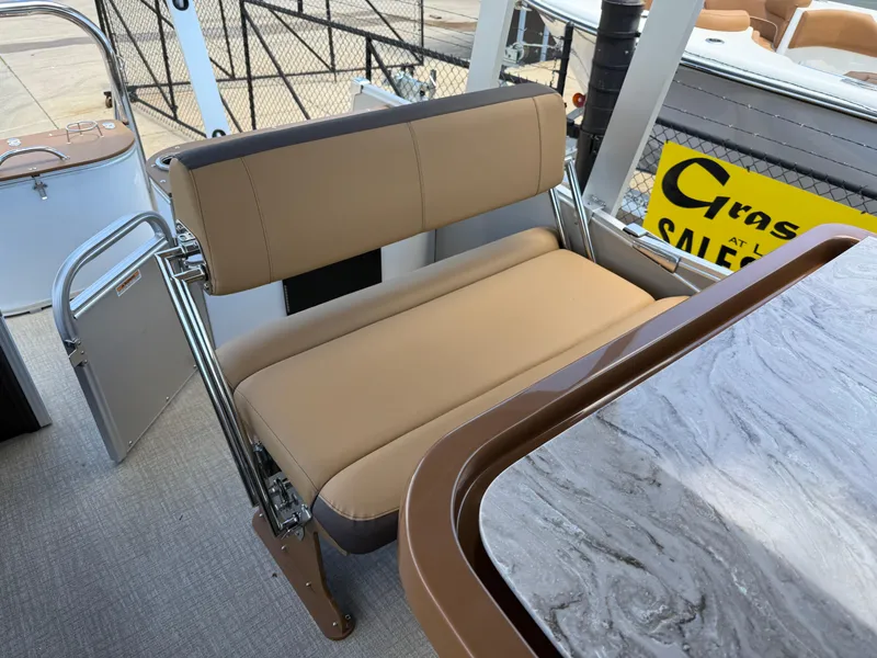 Slide: The Image of 2025 Avalon Catalina Entertainer Funship interior with beige seating and marble-style table. - 25