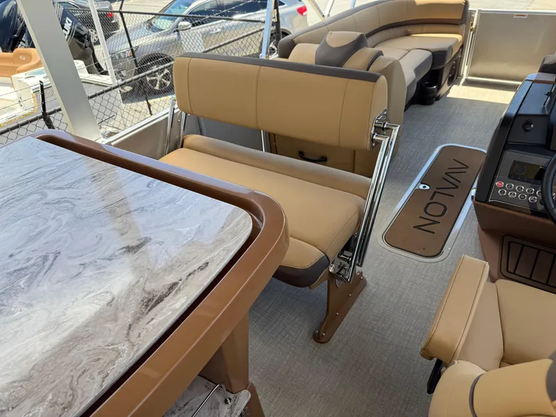 Slide: The Image of 2025 Avalon Catalina Entertainer Funship interior with luxurious seating and elegant table design. - 28