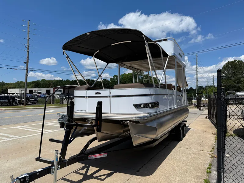 Slide: The Image of 2025 Avalon Catalina Entertainer Funship pontoon boat on trailer, sunny day, blue sky. - 3