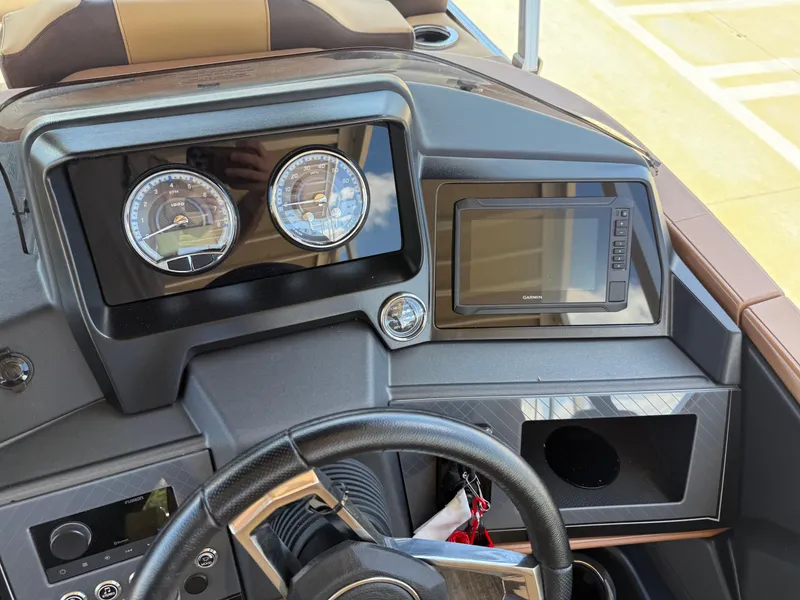 Slide: The Image of Dashboard of 2025 Avalon Catalina Entertainer Funship with gauges and navigation screen. - 31