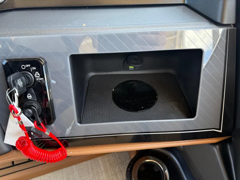 Slide: The Image of Control panel of 2025 Avalon Catalina Entertainer Funship with ignition switch and storage compartment. - 34