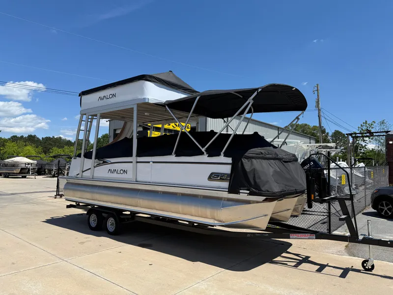 Slide: The Image of 2025 Avalon Catalina Entertainer Funship pontoon boat on trailer, parked outdoors. - 4