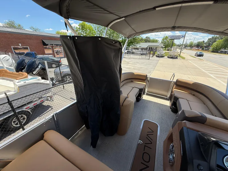 Slide: The Image of 2025 Avalon Catalina Entertainer Funship interior with seating and canopy, parked outdoors. - 43