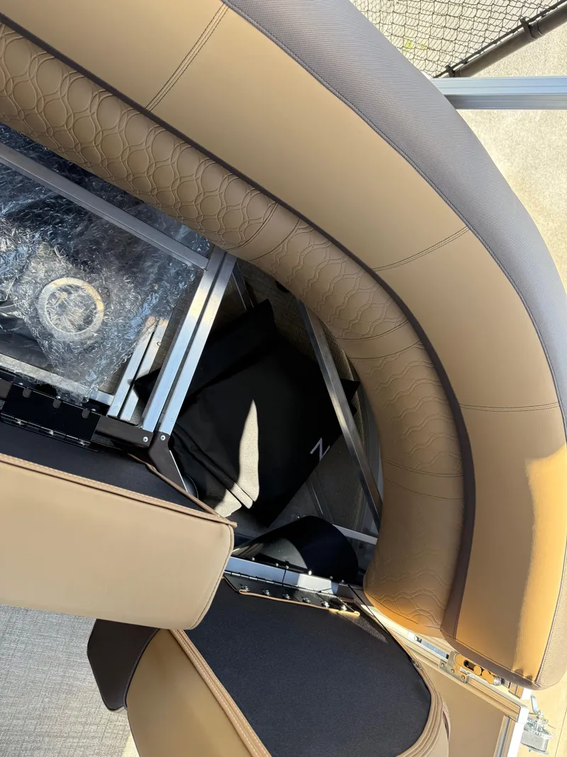 Slide: The Image of 2025 Avalon Catalina Entertainer Funship interior seating with tan upholstery and storage compartment. - 45