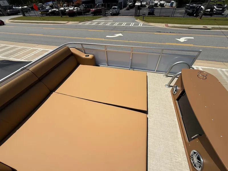 Slide: The Image of 2025 Avalon Catalina Entertainer Funship with spacious deck and seating, parked near a road. - 49