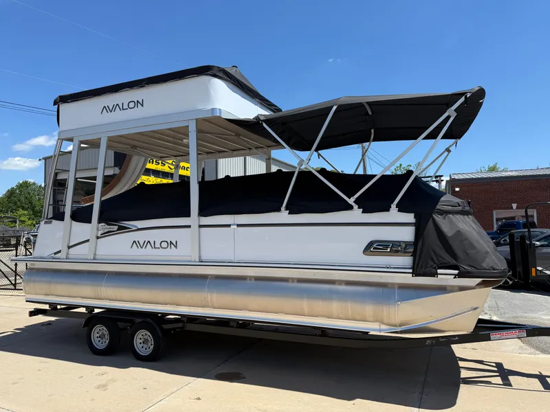 Slide: The Image of 2025 Avalon Catalina Entertainer Funship pontoon boat on trailer, outdoor display. - 5