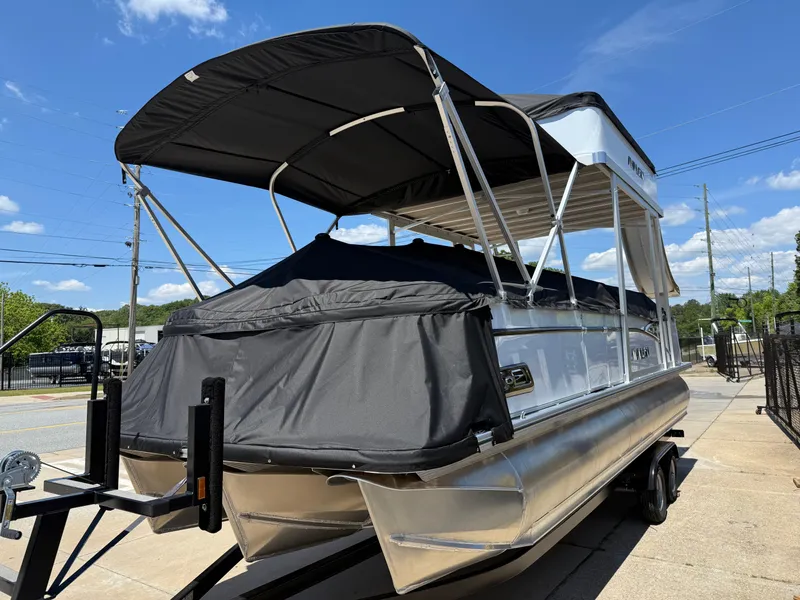 Slide: The Image of 2025 Avalon Catalina Entertainer Funship pontoon boat with black canopy on trailer. - 7