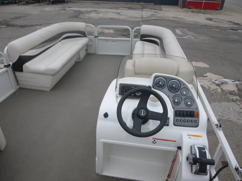 Slide: The Image of 2010 Crestliner Bata Bay 2185 boat interior with steering console and seating. - 1