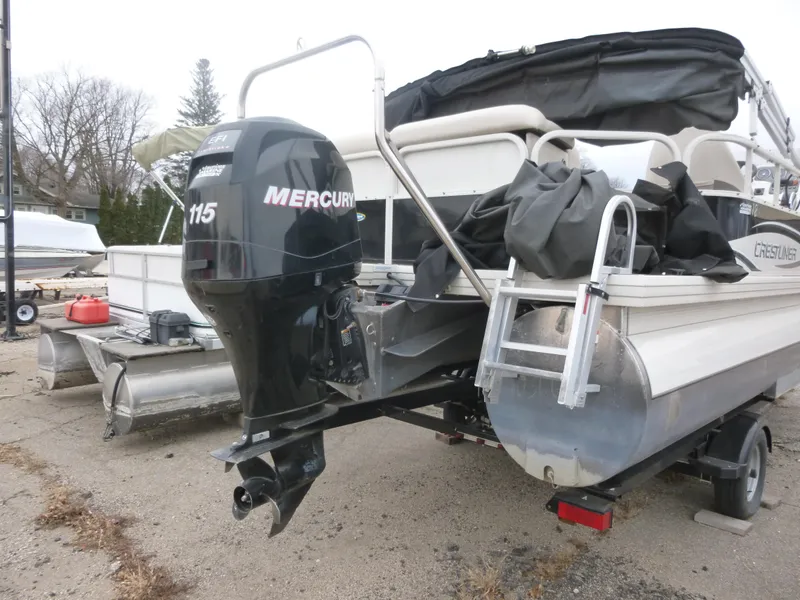 Slide: The Image of 2010 Crestliner Bata Bay 2185 boat with Mercury 115 outboard motor, parked on land. - 3