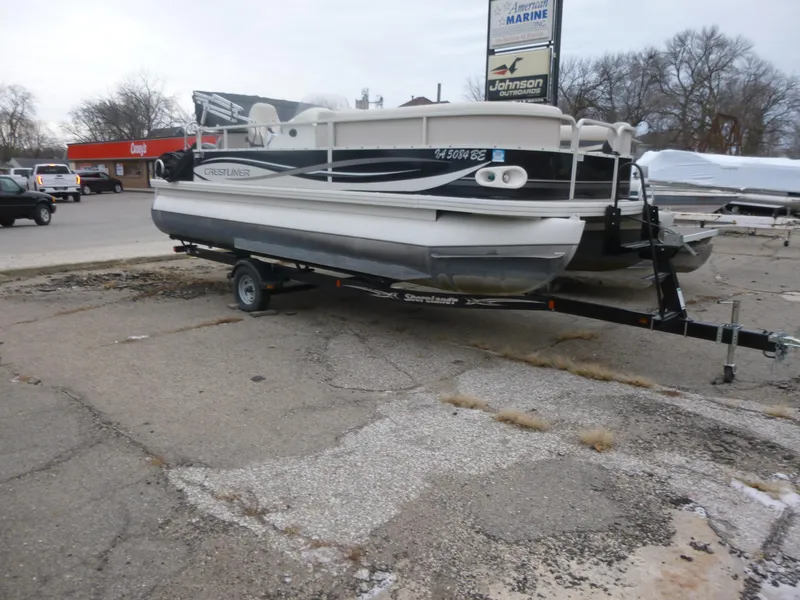 Slide: The Image of 2010 Crestliner Bata Bay 2185 pontoon boat on trailer in parking lot. - 4