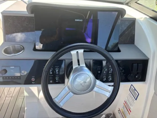 Slide: The Image of Steering wheel and dashboard of 2021 Sea Ray SDX 270 Outboard boat. - 10