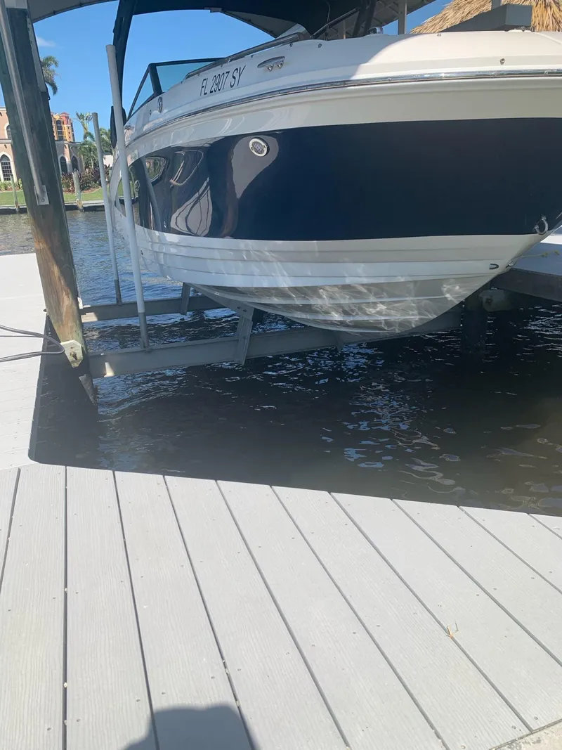 Slide: The Image of 2021 Sea Ray SDX 270 Outboard boat docked on a sunny day. - 12