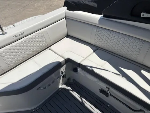 Slide: The Image of 2021 Sea Ray SDX 270 Outboard boat interior with white cushioned seating and hexagonal pattern. - 15