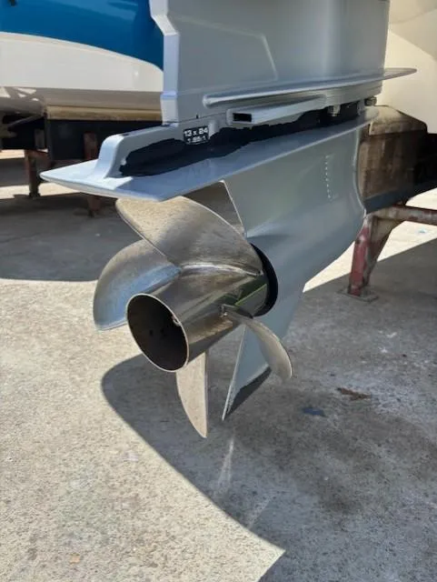 Slide: The Image of 2021 Sea Ray SDX 270 Outboard propeller, close-up view on concrete surface. - 21