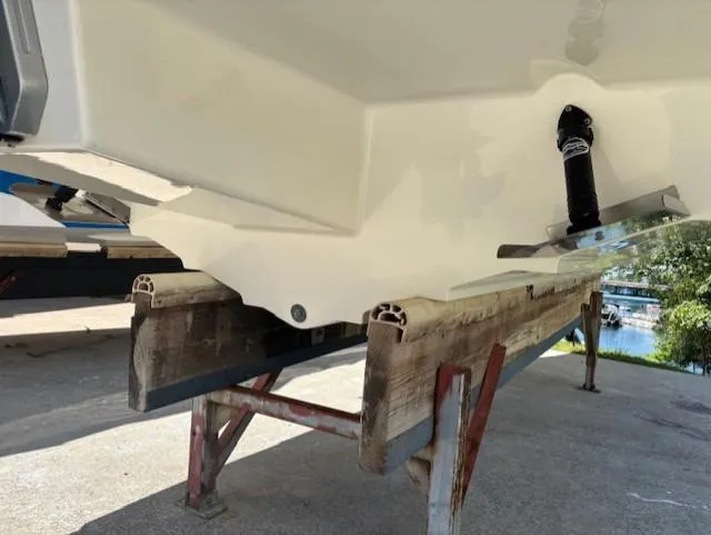 Slide: The Image of 2021 Sea Ray SDX 270 Outboard boat hull on a wooden stand. - 22
