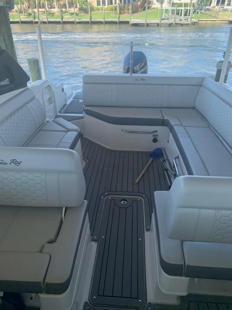 Slide: The Image of 2021 Sea Ray SDX 270 Outboard boat interior with spacious seating and elegant design. - 3