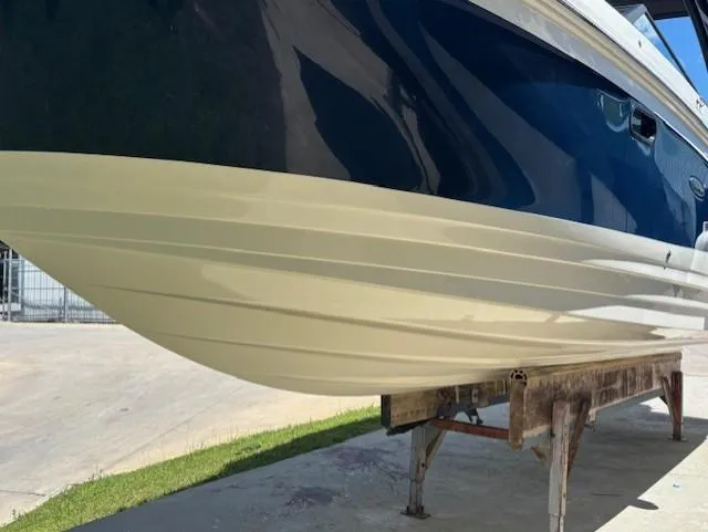 Slide: The Image of 2021 Sea Ray SDX 270 Outboard boat hull on display stand. - 6