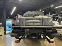 Slide: The Image of 2024 Sea-Doo Switch Cruise 21 pontoon boat displayed indoors, rear view. - 14