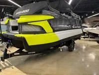 Slide: The Image of 2024 Sea-Doo Switch Cruise 21 in showroom, featuring vibrant yellow and black design. - 4