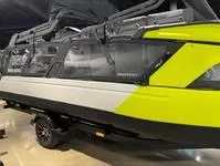Slide: The Image of 2024 Sea-Doo Switch Cruise 21, vibrant yellow and black design, side view in showroom. - 5