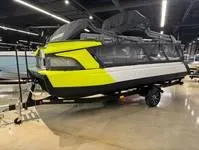 Slide: The Image of 2024 Sea-Doo Switch Cruise 21 in showroom, featuring vibrant yellow and black design. - 6