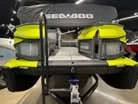 Slide: The Image of 2024 Sea-Doo Switch Cruise 21 pontoon boat, vibrant yellow, displayed indoors. - 7
