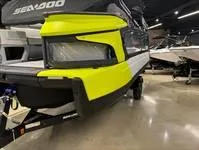 Slide: The Image of 2024 Sea-Doo Switch Cruise 21 in showroom, featuring vibrant yellow accents. - 8