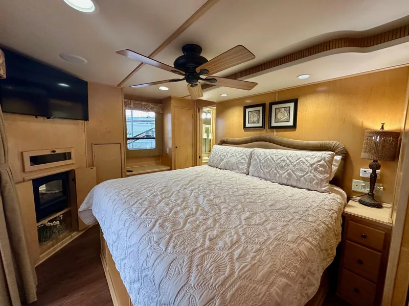 Slide: The Image of Luxurious bedroom in 2006 Stardust Cruisers 16x78 houseboat with king bed and modern amenities. - 10