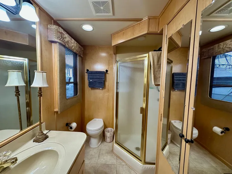 Slide: The Image of Luxurious bathroom in 2006 Stardust Cruisers 16x78 houseboat with shower, vanity, and toilet. - 11