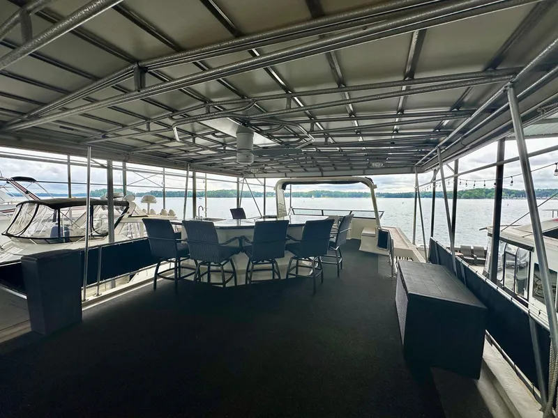 Slide: The Image of Spacious deck of 2006 Stardust Cruisers 16x78 houseboat with seating, overlooking serene waters. - 14