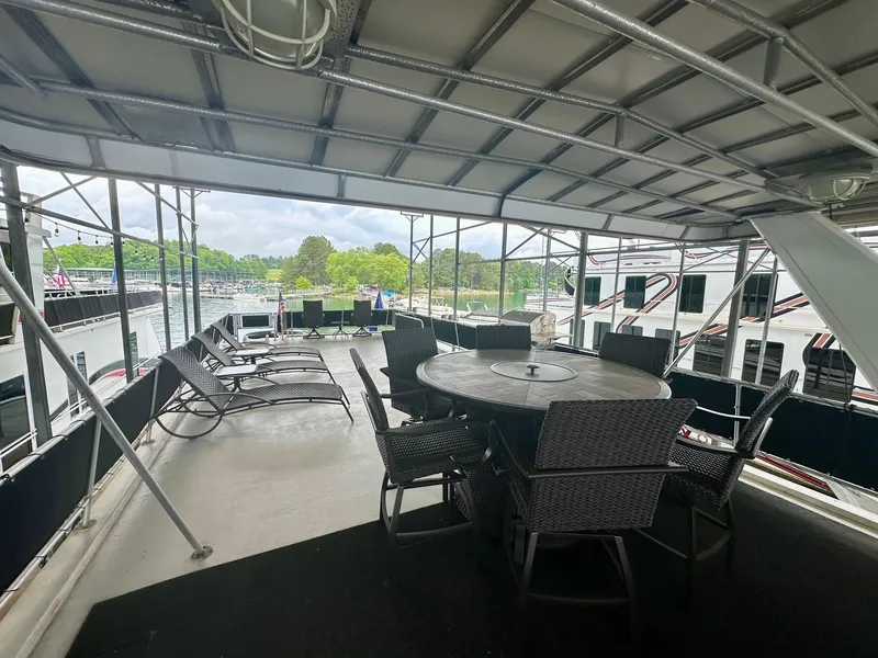 Slide: The Image of Covered deck of 2006 Stardust Cruisers 16x78 houseboat with outdoor seating and dining area. - 15