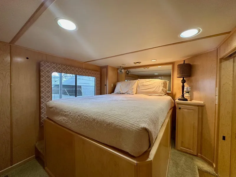 Slide: The Image of Luxurious bedroom interior of 2006 Stardust Cruisers 16x78 houseboat with cozy bed and ambient lighting. - 6