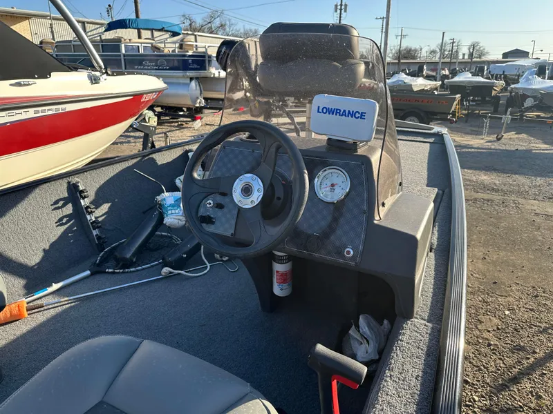 Slide: The Image of 2021 Tracker Bass Tracker Classic XL boat interior with steering wheel and Lowrance device. - 2