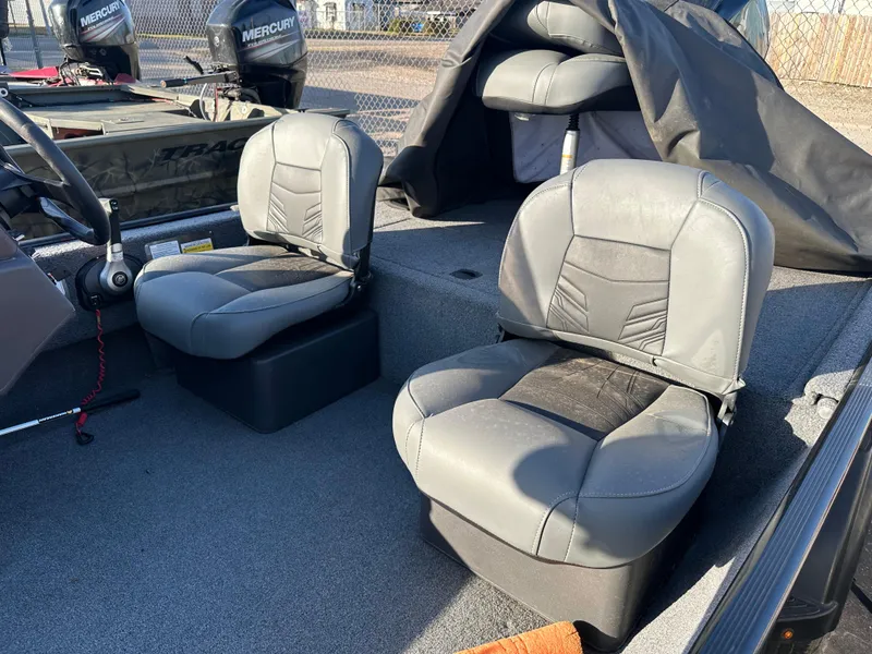 Slide: The Image of 2021 Tracker Bass Tracker Classic XL boat interior with gray seating and steering wheel. - 4