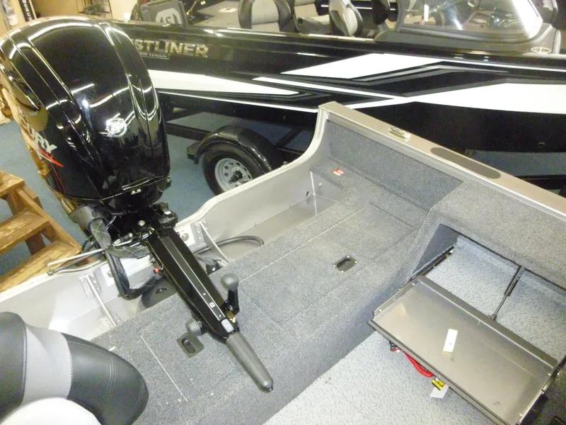Slide: The Image of 2025 Crestliner 1750 Pro Tiller boat interior with motor and storage compartments. - 3