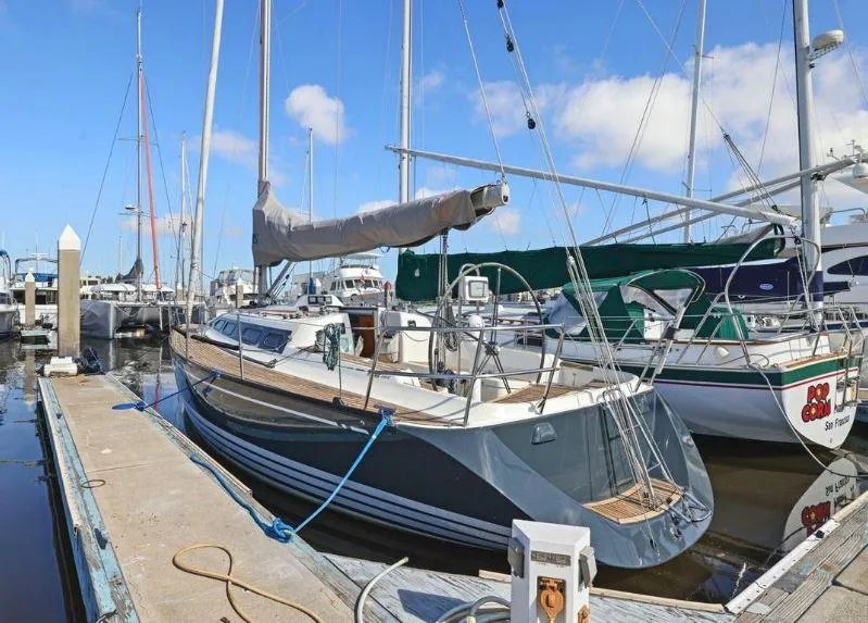 Slide: The Image of Sailboat X-Yachts X-362 Sport 2000 docked at marina under blue sky. - 1