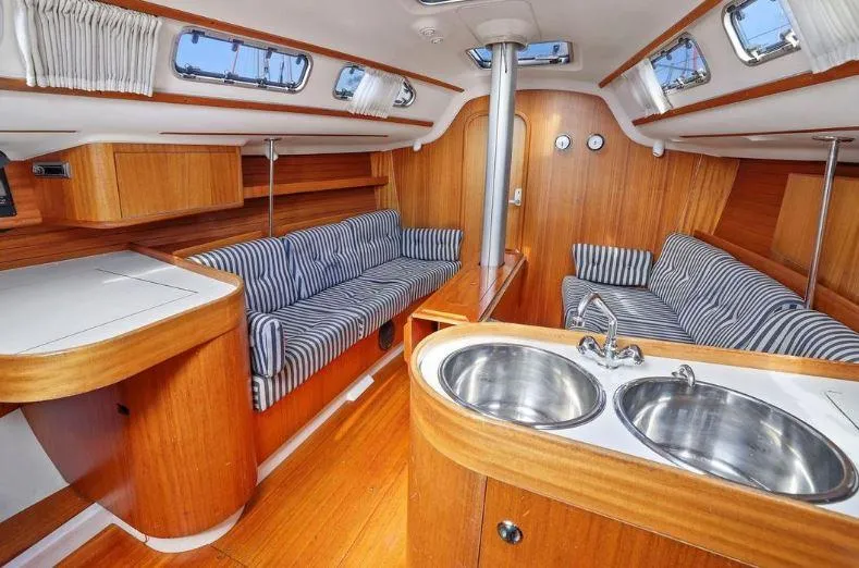 Slide: The Image of Interior of 2000 X-Yachts X-362 Sport with wood finish and striped seating. - 12