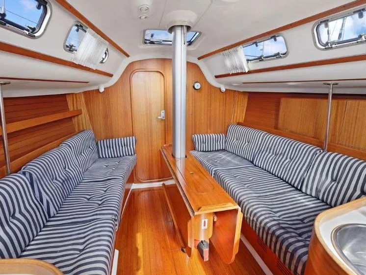 Slide: The Image of Interior of 2000 X-Yachts X-362 Sport with striped seating and wooden finishes. - 14