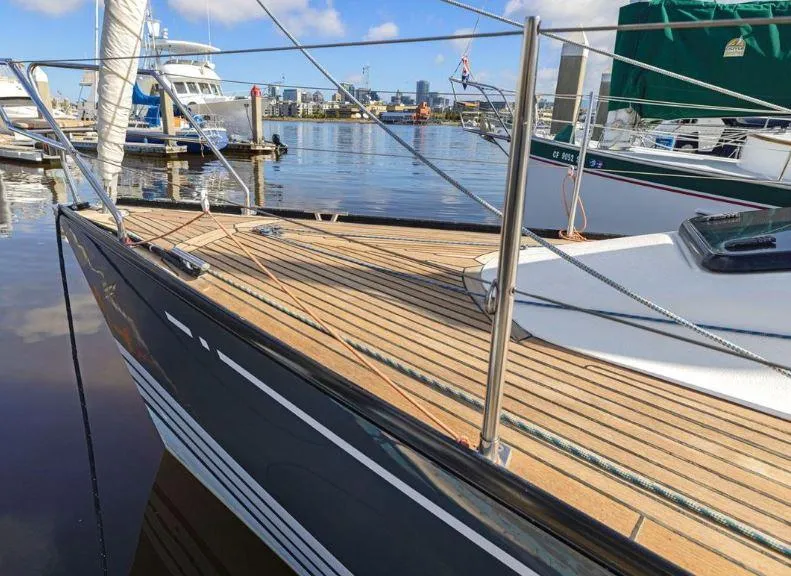 Slide: The Image of X-Yachts X-362 Sport 2000 sailboat docked at marina with wooden deck and sleek design. - 2