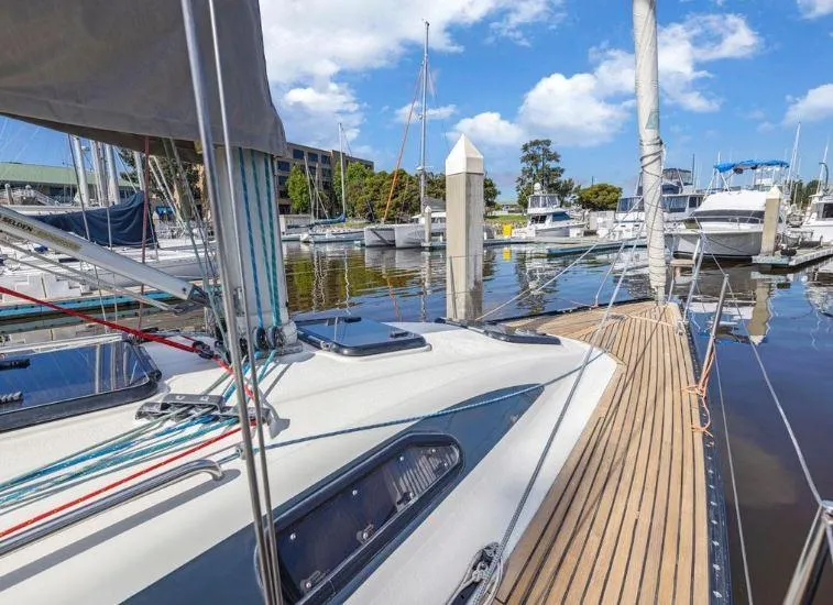 Slide: The Image of X-Yachts X-362 Sport 2000 sailboat docked in a marina, featuring sleek deck design. - 3