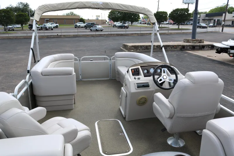 Slide: The Image of 2015 Bennington 24SSRX pontoon boat interior with beige seating and steering console. - 11